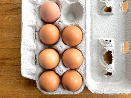 Brown eggs in a cardboard carton.